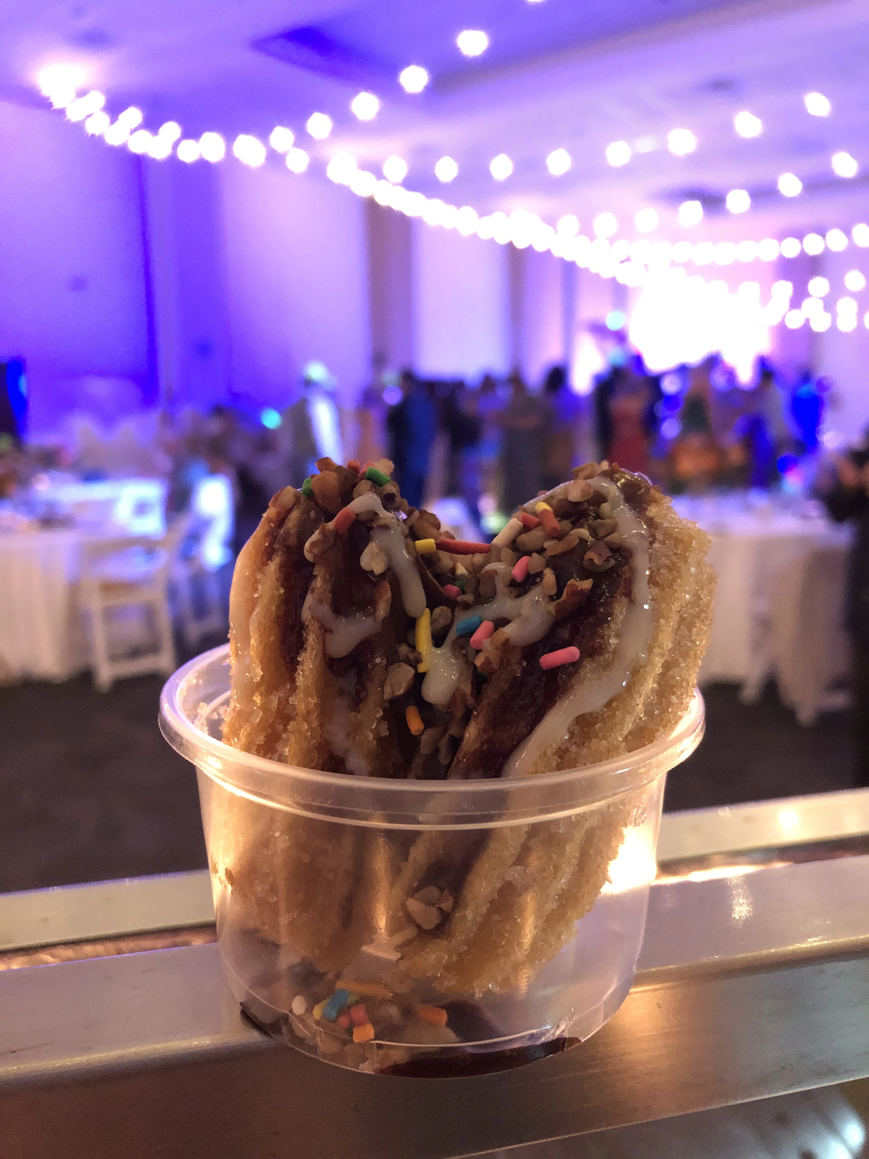 Churros with sweetened condensed milk and rainbow sprinkles